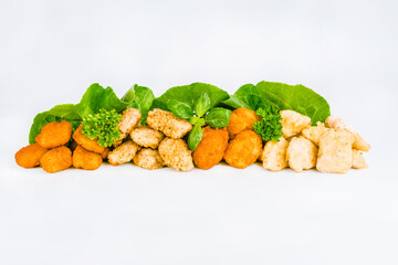 Assorted Breaded Chicken Inner Fillet,Chicken Breaded Raw Meat.Fast cooking.Breaded Chicken nuggets Fillet with salad on a White Background,food at home.Fast homemade food.Chicken breaded schnitzels.