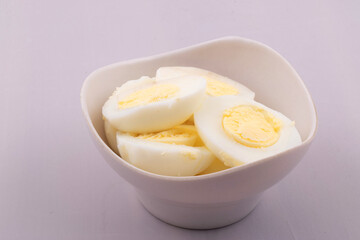 Boiled eggs in bowl on white background