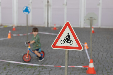 Warning sign near children riding bikes.