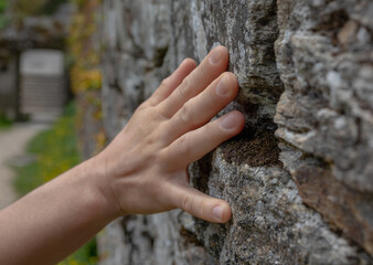 A Touch of Tranquility: Woman's Hand on the Stone Wall