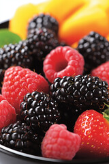 Blackberries and raspberries close up.
