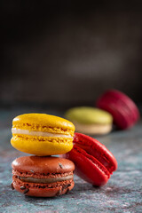 Delicious macaroons on the table. Macarons cakes in different colors.