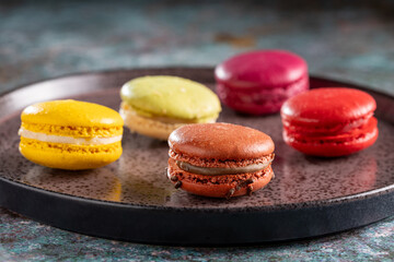 Delicious macaroons on the table. Macarons cakes in different colors.