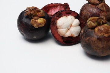 
Fresh ripe mangosteen fruit, white on the inside and brown or purple on the outside. The taste is sweet and refreshing. Isolated white background.