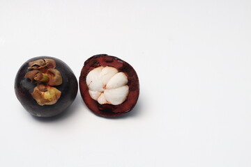 
Fresh ripe mangosteen fruit, white on the inside and brown or purple on the outside. The taste is sweet and refreshing. Isolated white background.