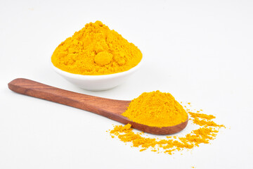 Haladi powder in spoon and bowl on white background, healthy indian spice