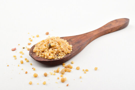 Asafoetida in spoon on white background