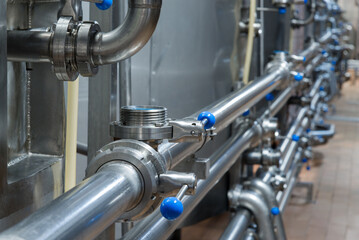 Industrial stainless steel pipework. Metal pipes, element of equipment design, of the milk...