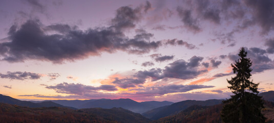 dramatic cloudscape above the mountains at dusk. sky in colorful evening light. changing weather forecast