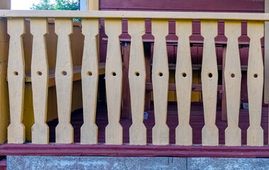 Painted Decorative boards of the porch fence of the house close-up in summer