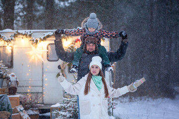 Family concept. Portrait of happy family father and mother with son in winter nature in snowy forest. Enjoying spending time together.