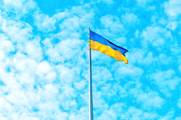 Blue and Yellow Ukrainian Flag Flying High against Blue Sky