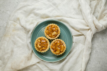Honey Nut Tart served in plate isolated on napkin top view of cafe baked food on background