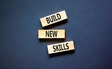 Build new skills symbol. Concept word Build new skills on beautiful wooden block. Beautiful black table black background. Business, education build new skills concept. Copy space.