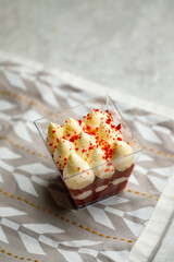 Red Velvet Mousse Jar isolated on napkin side view of cafe baked food on background