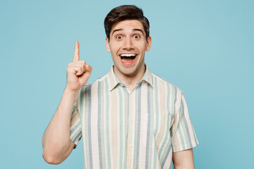 Young smiling excited happy man he wear striped shirt casual clothes holding index finger up with...