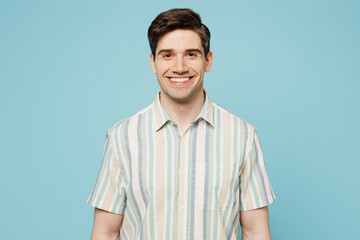 Young smiling happy cheerful satisfied man he wears striped shirt casual clothes looking camera...