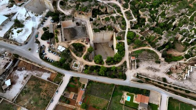 Aerial showcase of Minorca's limestone quarries amid a green landscape.