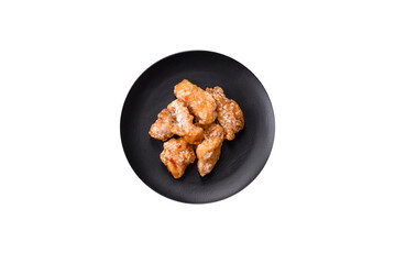 Delicious juicy grilled chicken pieces in sweet and sour sauce with salt and spices