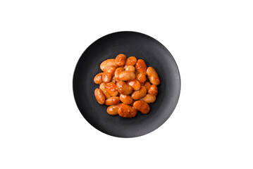 Delicious canned beans in a tomato in a round ceramic plate