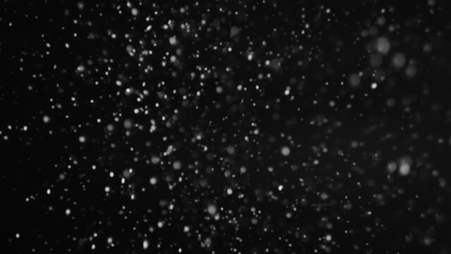 Snowfall particles. Blizzard storm. Abstract illustration of beautiful glowing soft snow falling cold night sky on dark background.