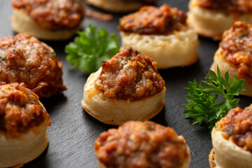 Cheese and BBQ sauce beans on mini crumpets. Party Finger food concept.