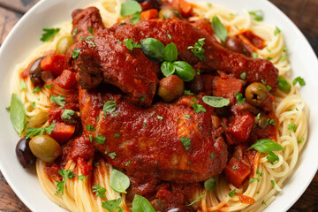 Cacciatore Chicken with spaghetti, vegetables, olives and tomatoes