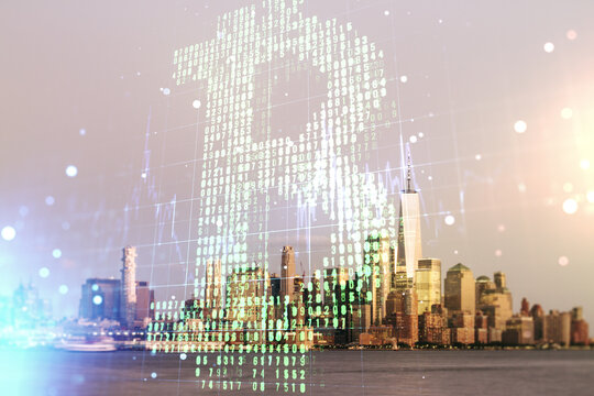 Double exposure of creative Bitcoin symbol hologram on New York city skyscrapers background. Cryptocurrency concept
