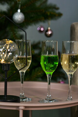 Glasses of New Year's drinks on the background of the New Year tree
