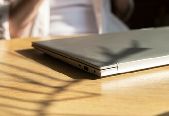 Closed laptop on wooden desk. Finished end done work