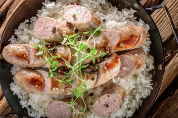 4K Image: Grilled Sausage Served Over Steaming White Rice, a Mouthwatering Dish