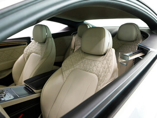 interior of a luxury coupe with light leather interior on a white background