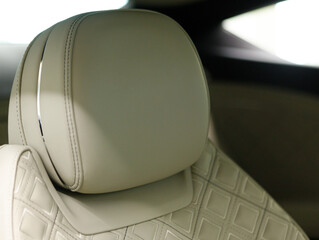 headrest of a luxury leather chair in the interior of an expensive sedan limousine
