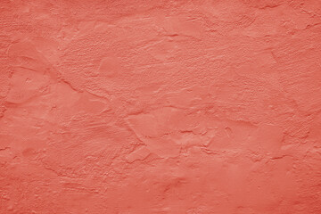 Old wall background. Rough grain grungy plaster texture surface. Red orange peach terracotta pink persimmon. Oil paint. Color. Urban vintage exterior. Close-up. For design. Template.