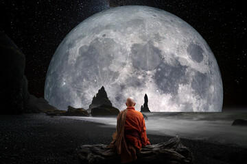 Buddhist monk observing the moon - obrazy, fototapety, plakaty