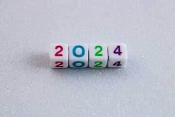 Year 2024, cubes with numbers on white glitter background
