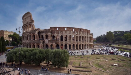 Panoramic view of the Colosseum (Colosseo, Anfiteatro Flavio)  from the Roman Forum in Rome, Italy	 - obrazy, fototapety, plakaty