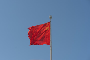 The flag of the USSR against the sky flutters in the wind