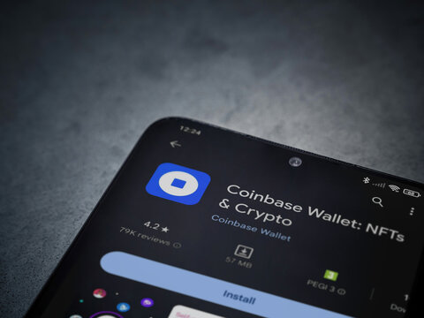 Lod, Israel - July 16,2023: Coinbase Wallet app play store page on smartphone on a dark marble stone background. Top view flat lay with copy space.
