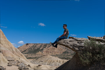 Man sitting on cliff in Bardenas reales