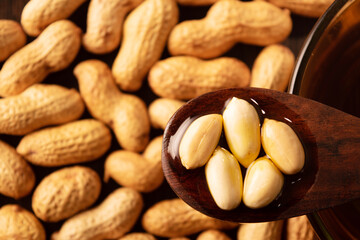 Top view of soaked peanuts in oil