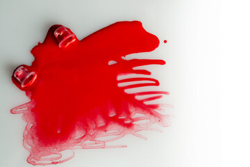 A jar with spilled red paint, paint background, pigments, ink for tattooing