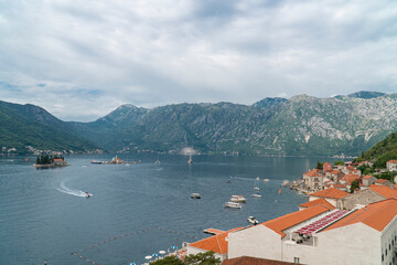 Coastline of the town Perast, Montenegro, aerial view. Mountains in the background, summer panoramic background 