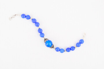 Top view of blue bead bracelet on white background