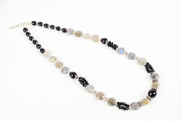Black and white bead necklace on white background