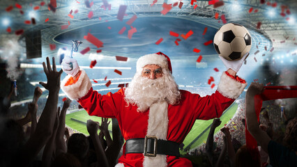 Santa claus ready to see a soccer match in a football stadium