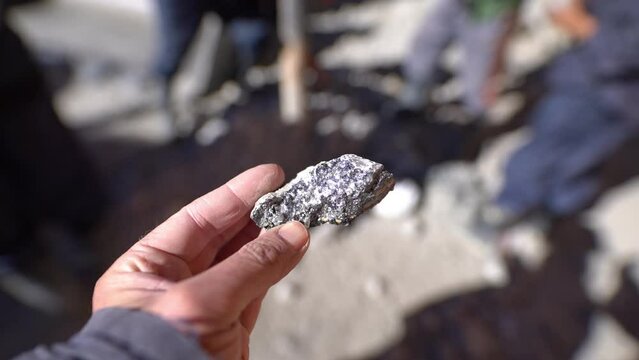 silver ore in shape of a small rock that needs to be processed to generate pure silver. Silver mining in Potosi in the andes mountains of Bolivia, South America
