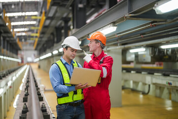 Teacher talking to apprentices at railway engineering facility