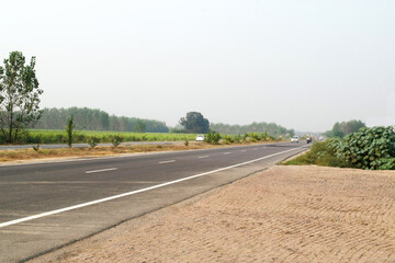 Fototapeta na wymiar Clean and empty highway road at uttar pradesh