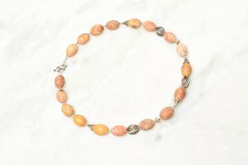 Handmade brown necklace on white background